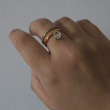 Load image into Gallery viewer, Hand wearing a gold ring with a diamond
