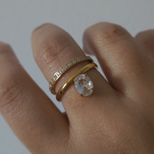 Load image into Gallery viewer, Hand wearing a gold ring with a diamond on a plain background
